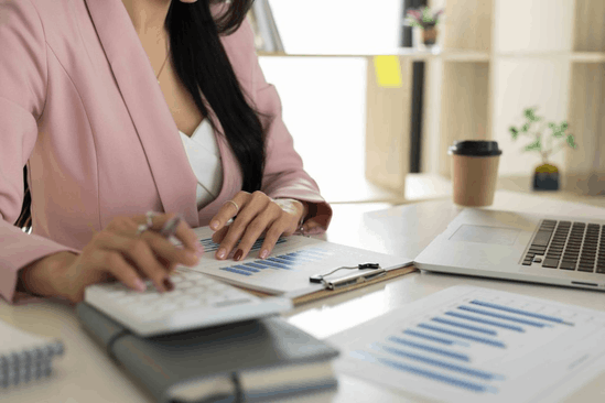 A tax preparer’s desk with paperwork and a laptop